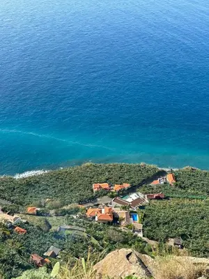 a group of houses on a hill near the water at Golden Moon, Ponta do Sol in Ponta do Sol