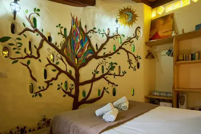 a bedroom with a tree mural on the wall at Casas Maravilha by Homie in Calheta
