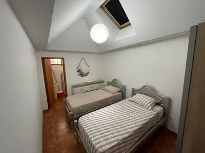 a bedroom with two beds and a ceiling at Cantinho DC in Funchal