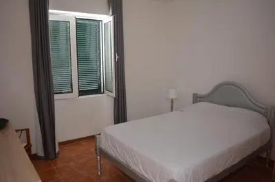 a bedroom with a closet and a dresser and a door at Cantinho DC in Funchal