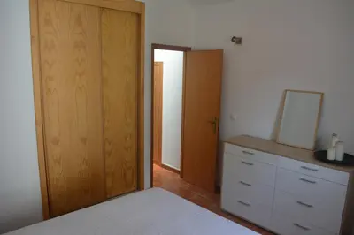 a bedroom with two beds and a door to a balcony at Cantinho DC in Funchal