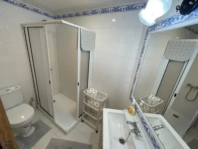 a bathroom with a shower and a toilet and a sink at Cantinho DC in Funchal