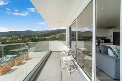 a balcony of a house with a view at Brand new apartment - Balcony with sea view in Arco da Calheta
