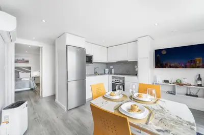 a kitchen with a table with two plates of food on it at Brand new private modern apartment with Patio and Sea View in Calheta