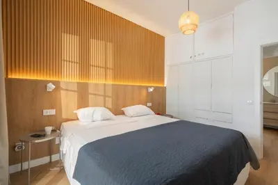 a bedroom with a large bed with a blue blanket at Casa da Palmeira by An Island Apart in Porto Santo