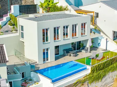 a view of a town with orange roofs and the ocean at JPL Blue Horizon Residential - Casa Horizon A in Câmara de Lobos