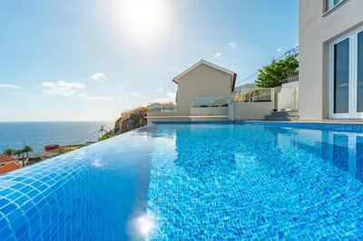 an aerial view of a town next to the ocean at JPL Blue Horizon Residential - Casa Horizon A in Câmara de Lobos