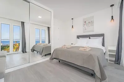 a bedroom with a bed and a view of the ocean at JPL Blue Horizon Residential - Casa Horizon A in Câmara de Lobos