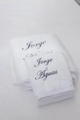 a stack of towels with the words forgive an forgive offensive at Apartamentos Jorge Águas - 2Bedroom in the town of Burgau - Sea view in Burgau