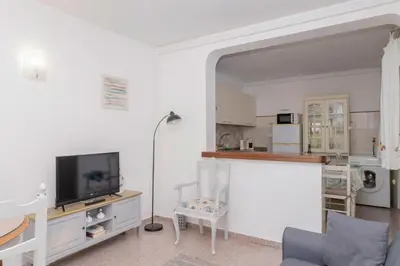a living room with a tv and a couch at Apartamentos Jorge Águas - 2Bedroom in the town of Burgau - Sea view in Burgau