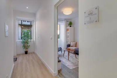 a kitchen and dining room with a wooden table and chairs at Upgrade Paradise Apartments Funchal City Centre in Funchal