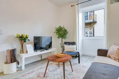a bedroom with a bed and a window with a chair at Upgrade Paradise Apartments Funchal City Centre in Funchal