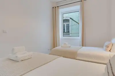 a kitchen with a table and chairs and a refrigerator at Upgrade Paradise Apartments Funchal City Centre in Funchal