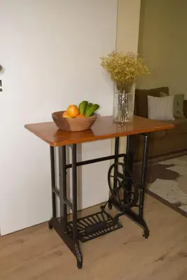 a table with a bowl of fruit and a vase of flowers at Sonho Paixão in São Vicente