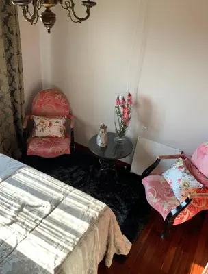 a bedroom with a bed and a table and a chair at Quinta J.V. in Camacha