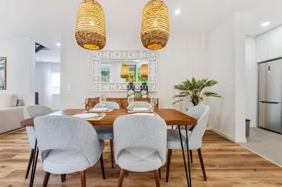 a dining room with a wooden table and chairs at Coastal Charm by Homie in Ponta do Sol