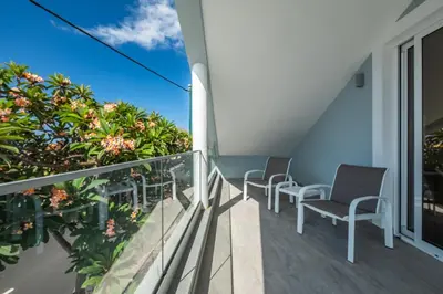 a balcony with chairs and a view of the ocean at Coastal Charm by Homie in Ponta do Sol