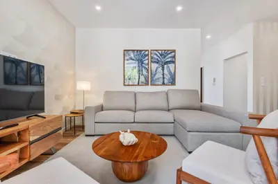 a living room with a couch and a table at Coastal Charm by Homie in Ponta do Sol
