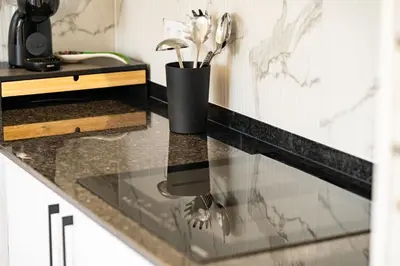 a kitchen counter with a glass counter top at JPL Blue Horizon Residential - D in Câmara de Lobos