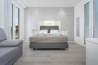 a bedroom with a bed and a couch at JPL Blue Horizon Residential - Casa Blue B & C in Câmara de Lobos