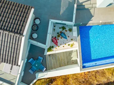 an overhead view of a swimming pool next to a house at JPL Blue Horizon Residential - Casa Blue B & C in Câmara de Lobos