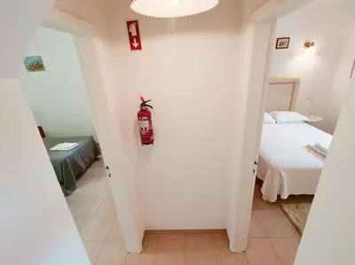 a bedroom with a bed and a fire extinguisher on the wall at Casa do Guarda - Arrifana beach 5min walk in Praia da Arrifana