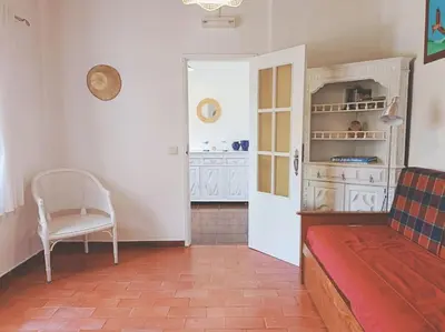 a living room with a couch and a chair at Casa do Guarda - Arrifana beach 5min walk in Praia da Arrifana