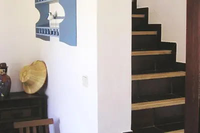 a staircase in a living room with wooden steps at Casa do Guarda - Arrifana beach 5min walk in Praia da Arrifana