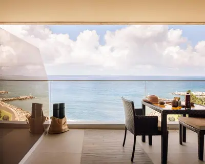 a dining room with a view of the ocean at Saccharum - Resort and Spa - Savoy Signature in Calheta