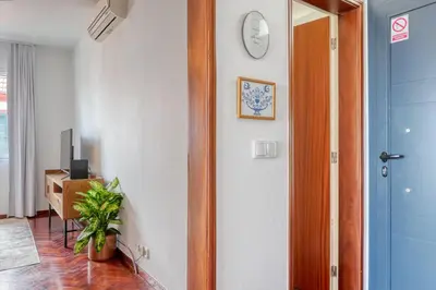 a hallway with a door and a clock on a wall at Clarisse's House I, a Home in Madeira in Ponta do Sol