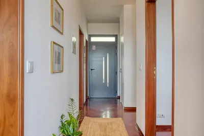 a hallway with a blue door and a room with a table at Clarisse's House I, a Home in Madeira in Ponta do Sol
