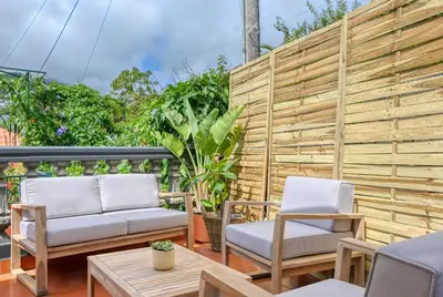 two chairs and a table on a patio at Clarisse's House I, a Home in Madeira in Ponta do Sol
