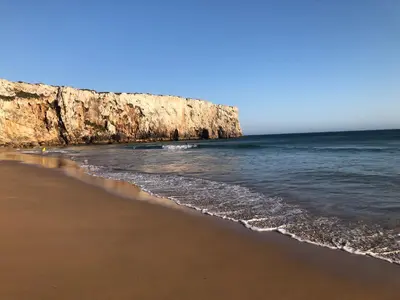 a beach with the ocean and a cliff at Casa da Bisa in Sagres
