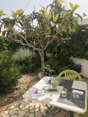 a table with a glass of wine on it at Casa da Bisa in Sagres