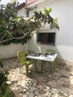 a table and two chairs on a stone patio at Casa da Bisa in Sagres