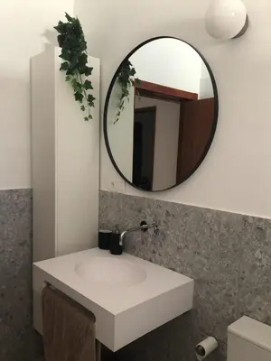 a bathroom with a white sink and a mirror at Casa da Bisa in Sagres