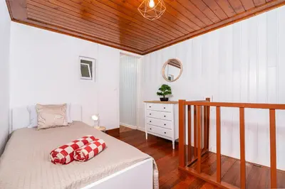 a bedroom with a bed and a wooden ceiling at Casa da Tia in Arco da Calheta