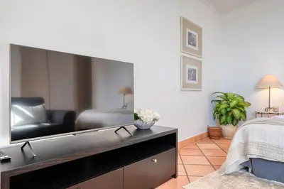 a living room with a large flat screen tv at Clarisse's House II, a Home in Madeira in Ponta do Sol