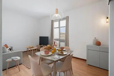 a living room with a table and chairs in a room at Apartamento América by An Island Apart in Funchal