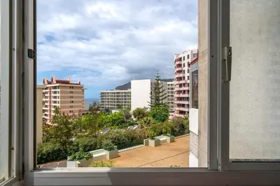 an open window with a view of a city at Apartamento América by An Island Apart in Funchal