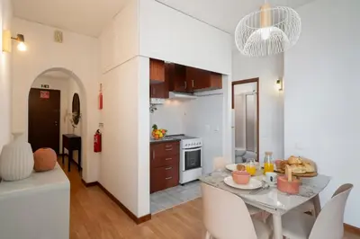 a kitchen and dining room with a table and chairs at Apartamento América by An Island Apart in Funchal