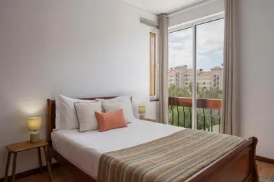 a bedroom with a bed and a large window at Apartamento América by An Island Apart in Funchal
