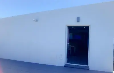 a white wall with a door in a building at Quintinha das Achadas in Achadas da Cruz