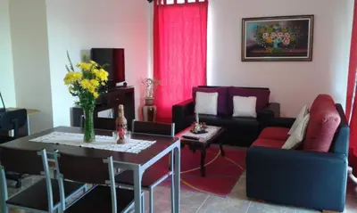 a living room with a couch and a table at AL - Perola Dourada in Santana