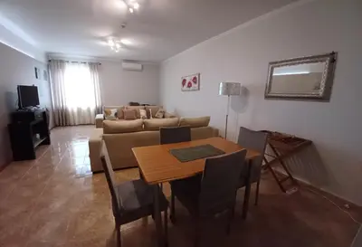 a living room with a table and a couch at AL - Perola Dourada in Santana