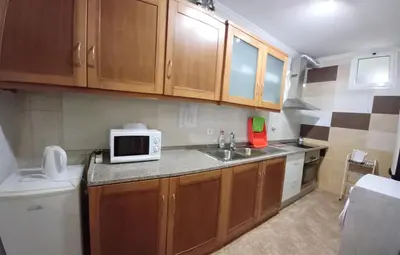 a small kitchen with a sink and a microwave at AL - Perola Dourada in Santana