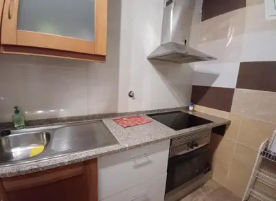 a small kitchen with a sink and a stove at AL - Perola Dourada in Santana