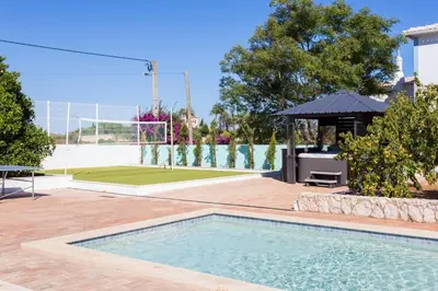 a swimming pool in a yard with a gazebo at Villa Cristallo in Caliços