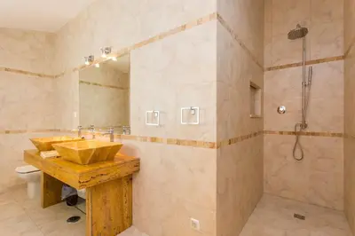 a bathroom with two sinks and a shower at Villa Cristallo in Caliços