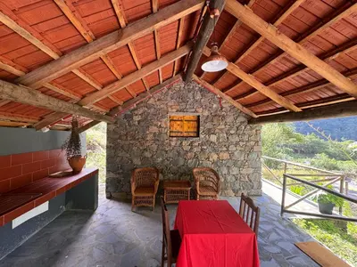 a dining room with a red table and chairs at Casa do Batista in Seixal